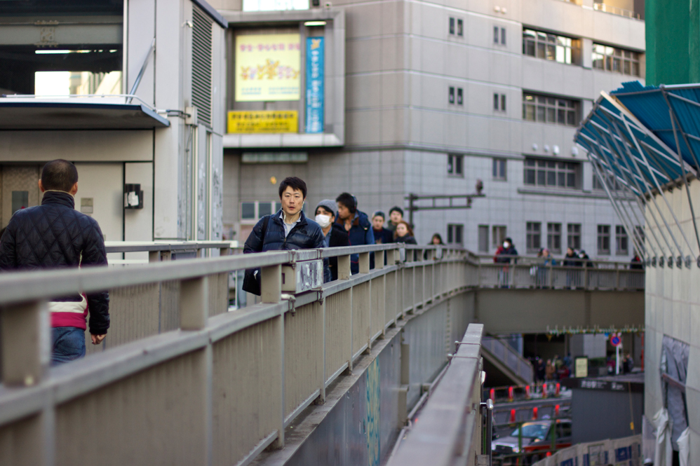 view of people walking on an overpass