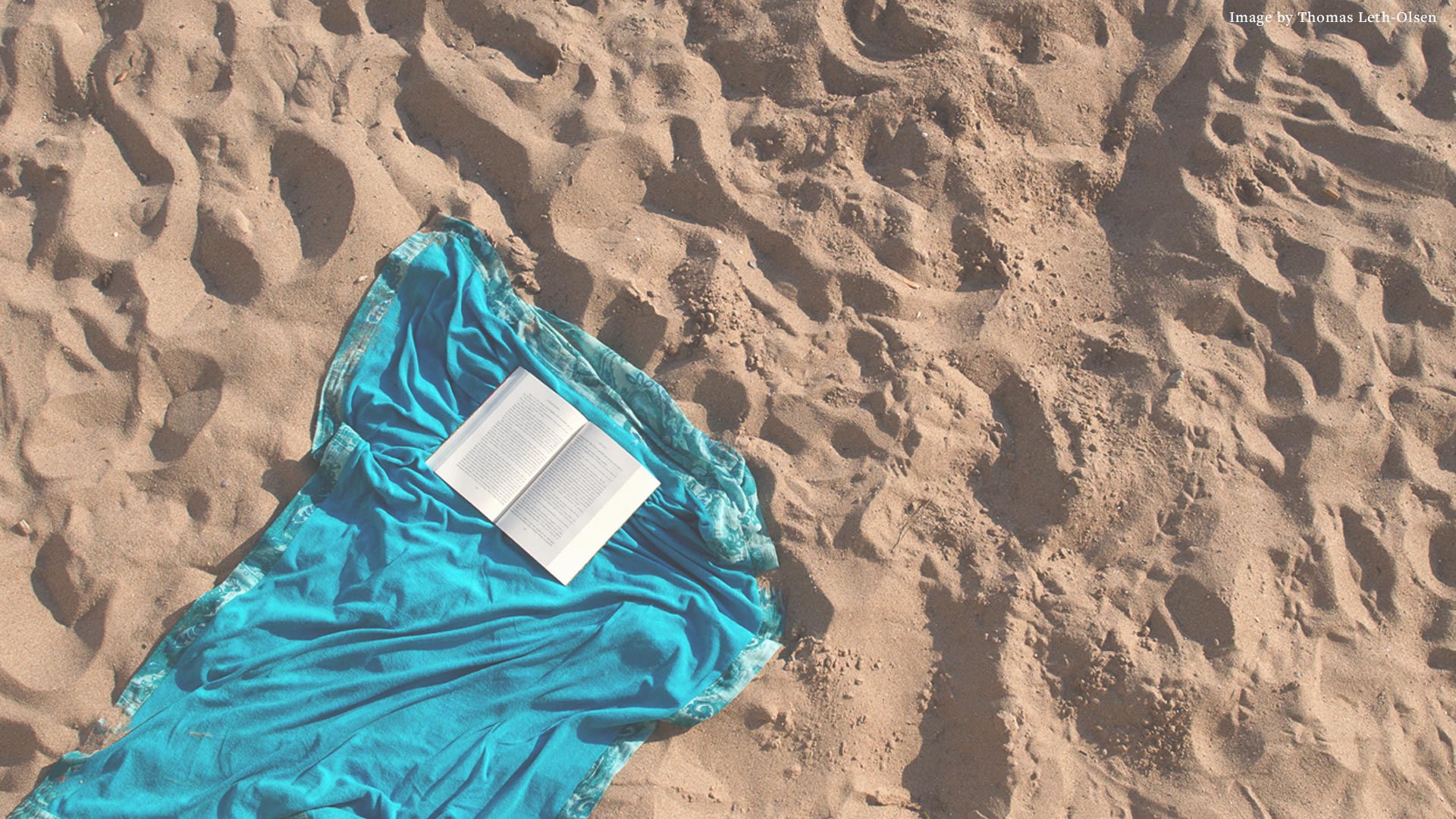 Open book on the sand