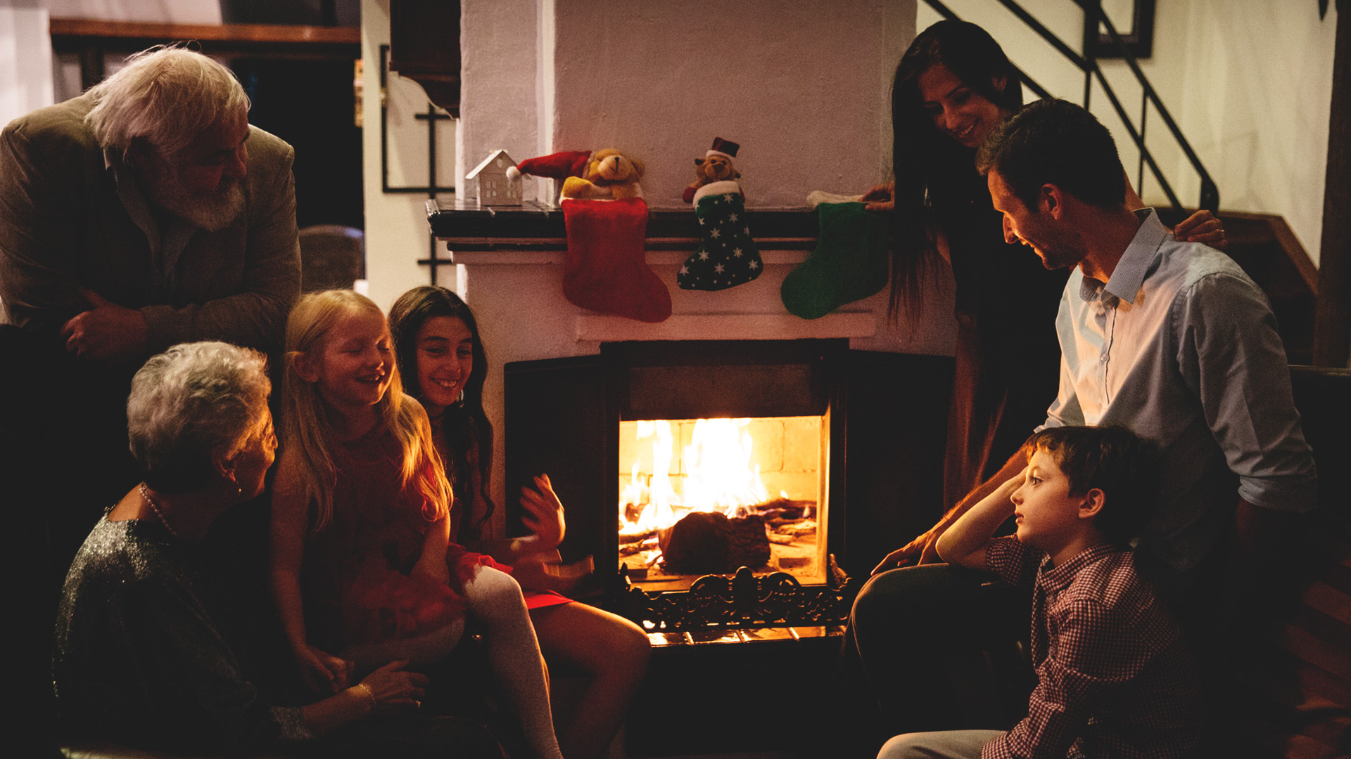 Family gathered at the fireplace at Christmas time
