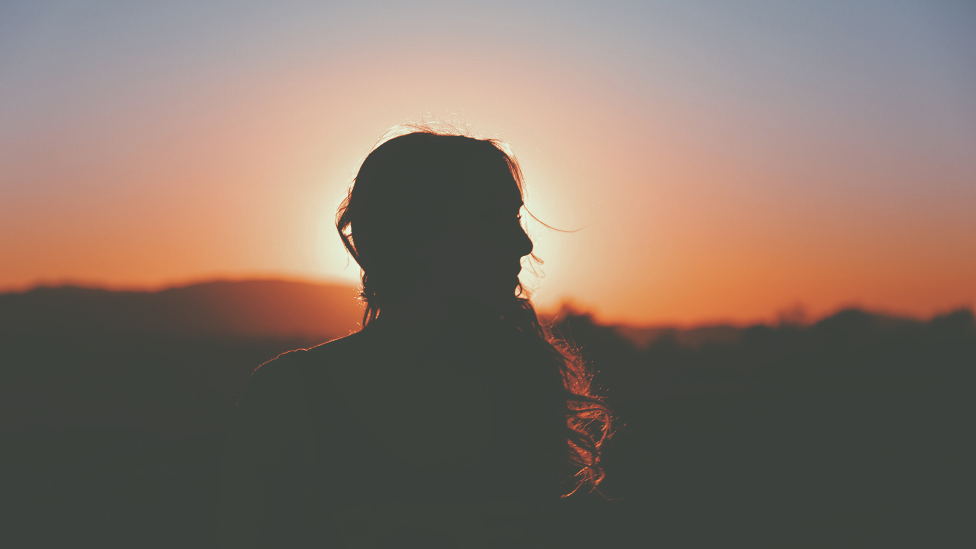 Woman silhouette against the sunset